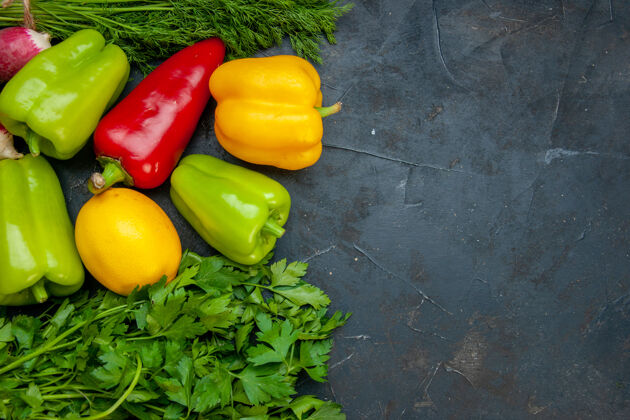 胡椒顶视图蔬菜不同颜色的甜椒柠檬欧芹莳萝在黑暗的桌子上复制空间甜椒绿色顶部