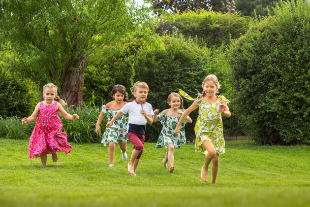 活跃有趣的开始儿童时尚概念一群少年男孩和女孩在公园跑步幼儿园年龄游戏