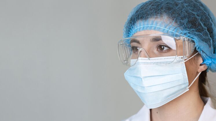 研究戴着护目镜 发网和医用面罩的女科学家调查网络炼金术