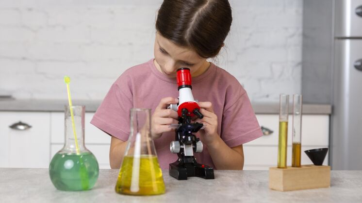 试管女孩用显微镜和试管做实验的前视图化学科学家炼金术