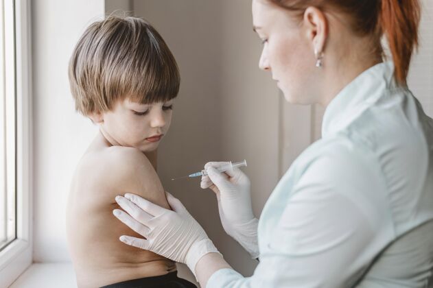 接种医生带着孩子在打疫苗儿童注射器免疫