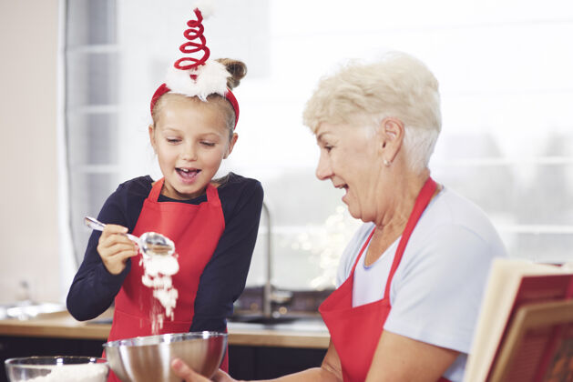 食物奶奶和女孩一起做饼干厨房圣诞节关闭