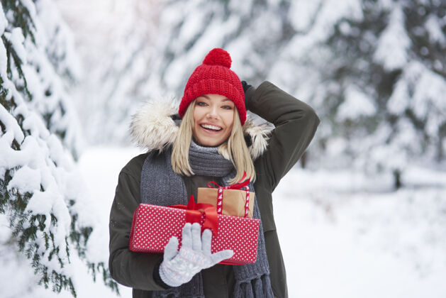 美丽快乐的女人手里拿着一堆圣诞礼物年轻时尚雪