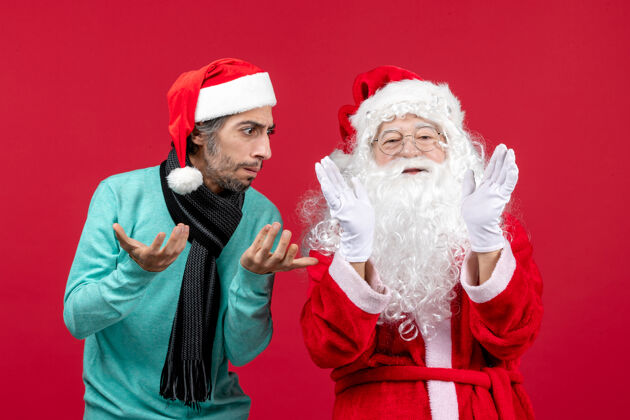 圣诞正面图：圣诞老人和年轻的男性站在一起圣诞老人站立男人