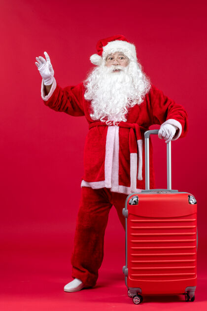 圣诞老人红墙上的圣诞老人和他的红包的正视图假期前面时尚