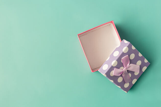辉光浅绿色背景带蝴蝶结的礼物盒新年节日包装